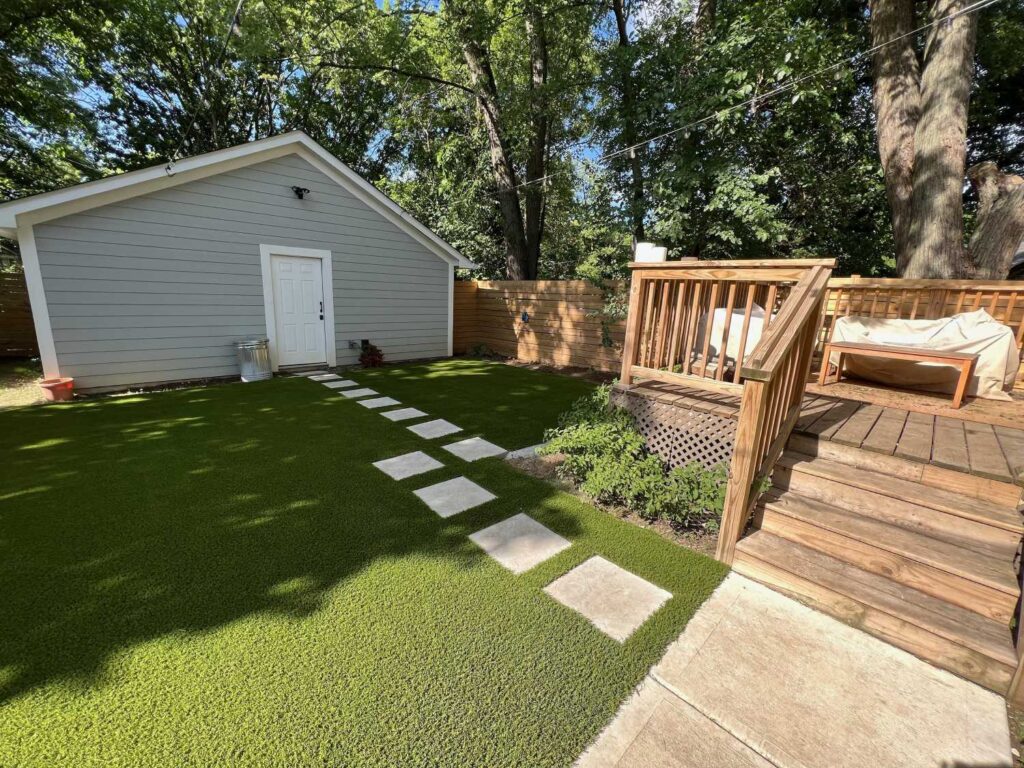 Residential artificial grass backyard with shack.