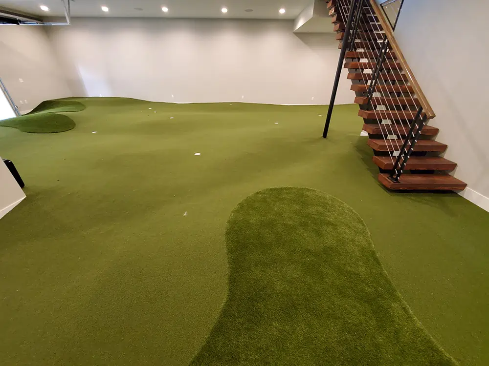 indoor basement putting green installed around stairs