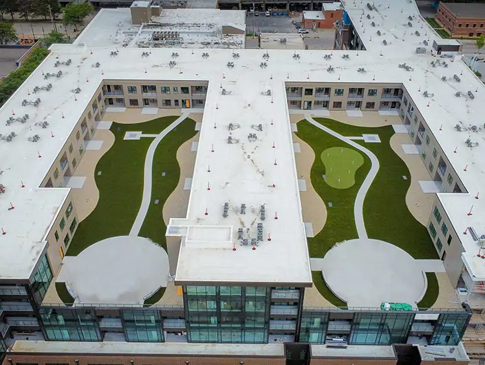 Drone shot of riverfront promenade rooftop from SYNLawn
