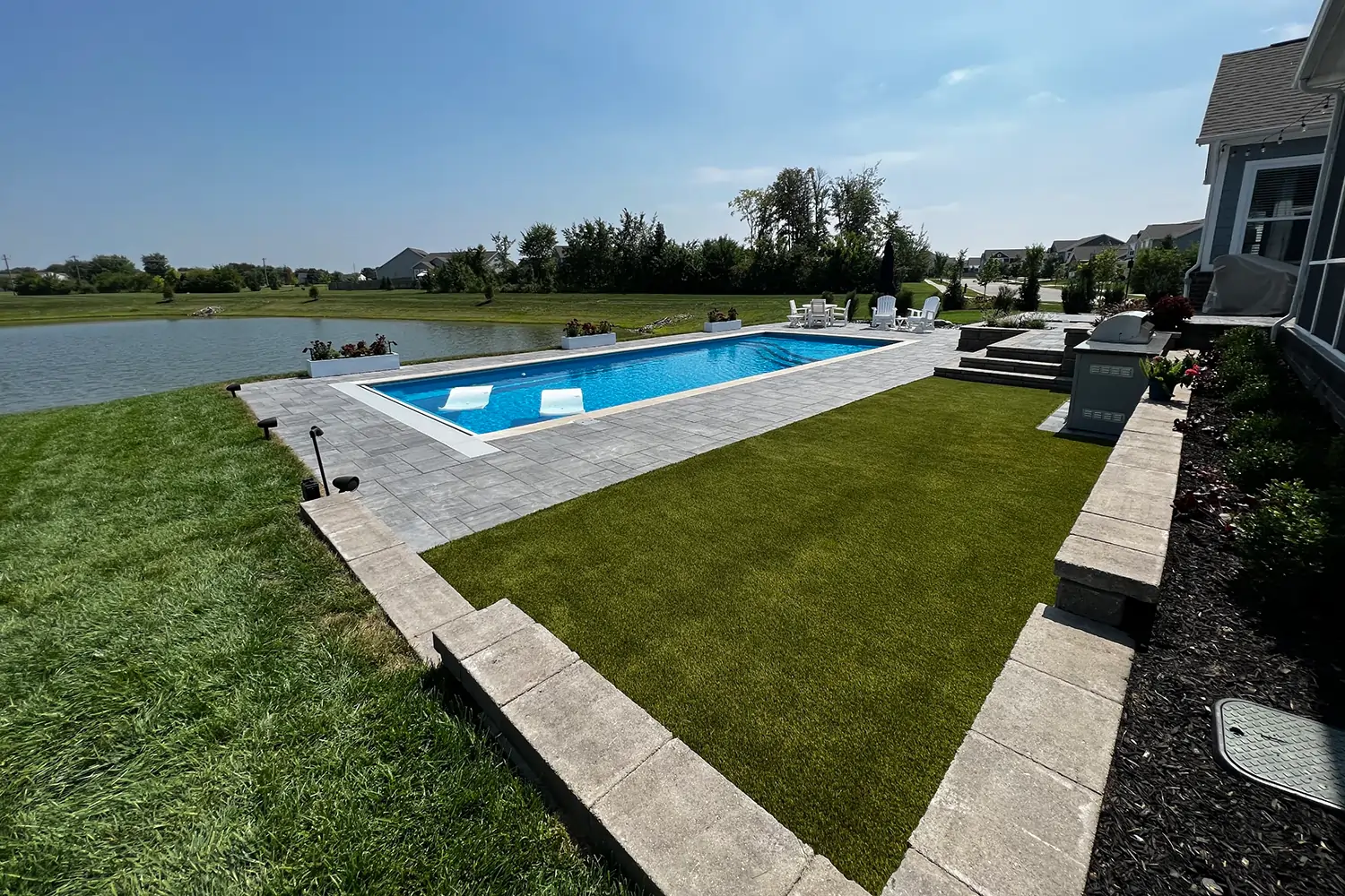 Artificial grass backyard pool area installed by SYNLawn